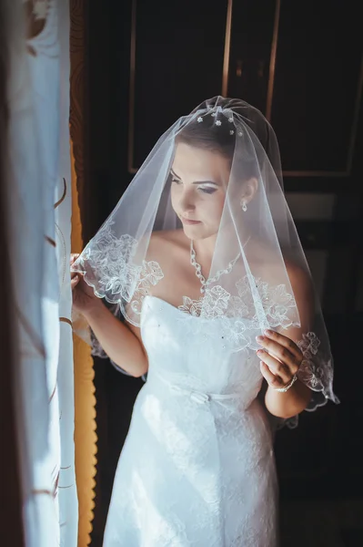 A noiva está a preparar-se. noiva bonita em vestido de noiva branco com penteado e maquiagem brilhante. Menina sexy feliz à espera de noivo. Senhora romântica em vestido de noiva tem preparação final para o casamento — Fotografia de Stock