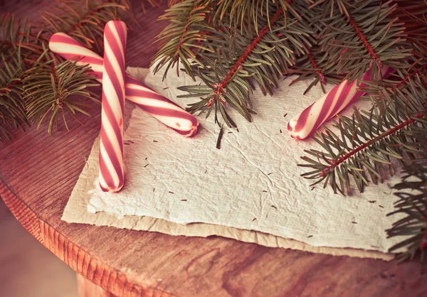 Pine tree branches with candy canes — Stock Photo, Image