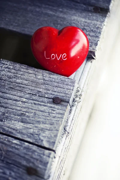 Red heart on wooden table — Stock Photo, Image