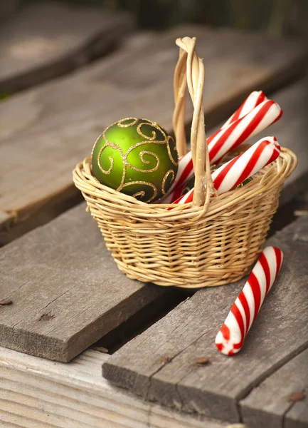 Christmas  candies and balls in basket — Stock Photo, Image