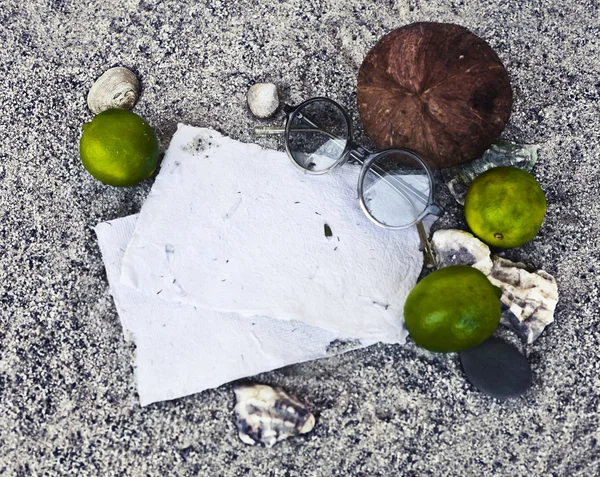 Papers, limes, coconut and sunglasses — Stock Photo, Image