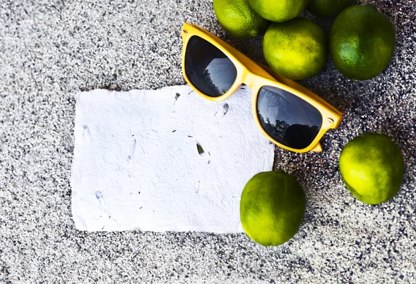 Papers, limes and sunglasses — Stock Photo, Image