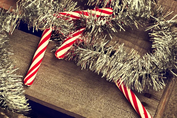 Christmas candy canes and tinsel — Stock Photo, Image