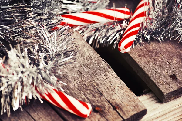 Christmas candy canes and tinsel — Stock Photo, Image