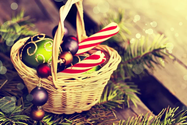 Christmas  candies and balls in basket — Stock Photo, Image