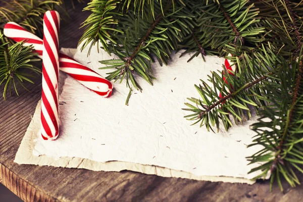 Christmas candies and fir branches — Stock Photo, Image