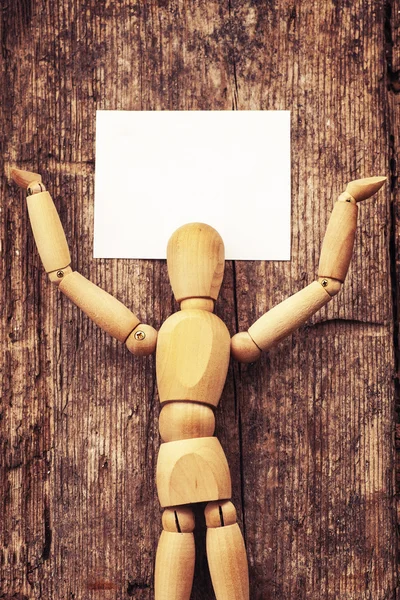 Wooden man holding  card — Stock Photo, Image