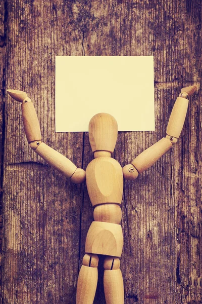 Wooden man holding  card — Stock Photo, Image