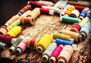 Bobbins with colorful threads clipart