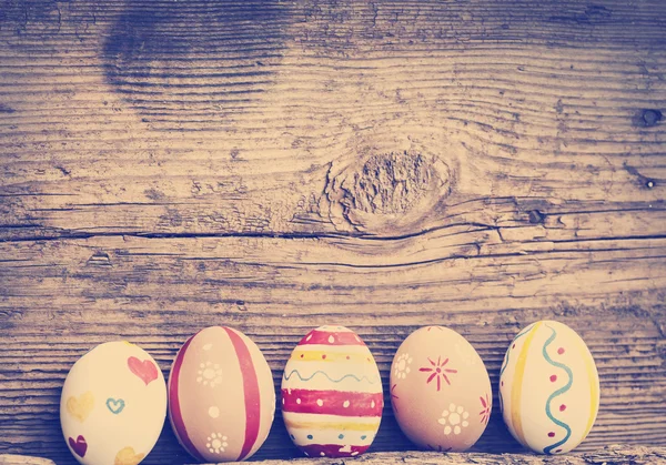 Easter eggs on old wooden background — Stock Photo, Image