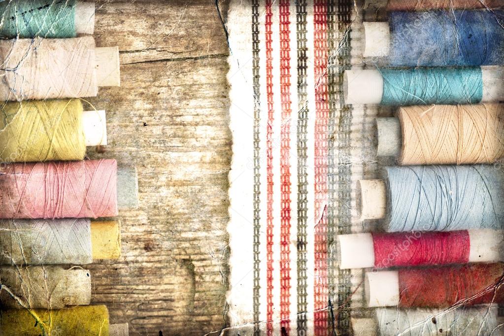 bobbins with threads and striped fabric