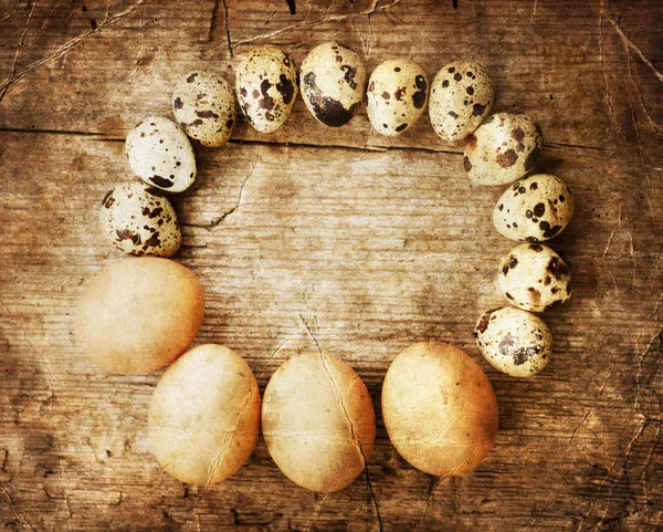 Яйца перепелов и цыплят на деревянном столе — стоковое фото