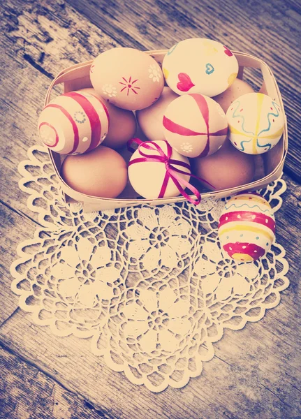 Colorful Easter eggs in a little basket. — Stock Photo, Image