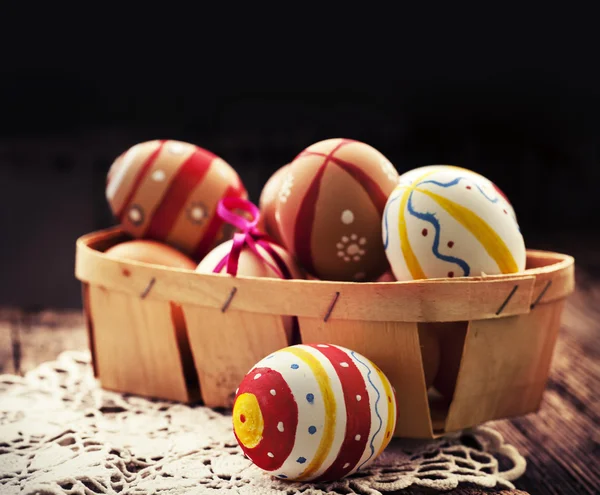 Colorful Easter eggs in a little basket. — Stock Photo, Image