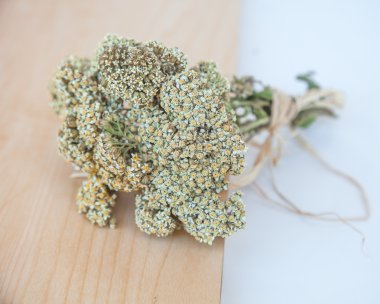 Milfoil flowers on wooden table