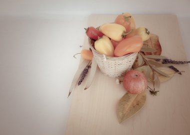 Little peppers, autumn leaves and apple