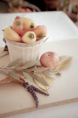 Little peppers, autumn leaves and apple