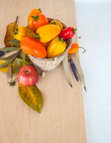 Little peppers, autumn leaves and apple — Zdjęcie stockowe