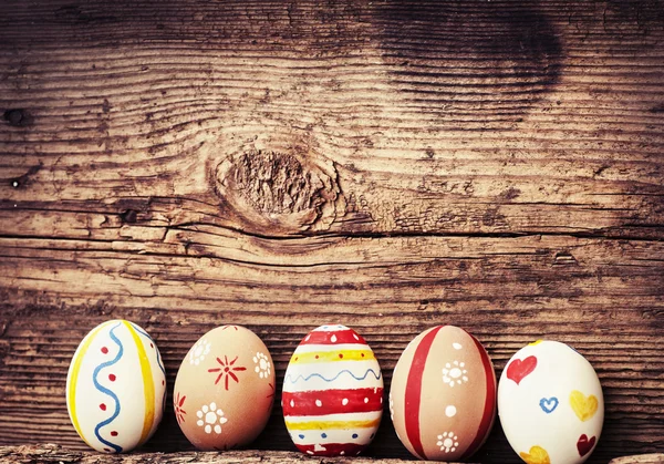 Easter eggs on old wooden background — Stock Photo, Image