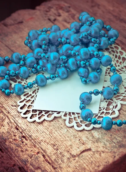 Blue beaded necklace and paper card — Stock Photo, Image