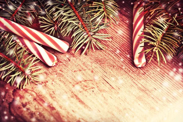 Pine tree branches with candy canes — Stock Photo, Image