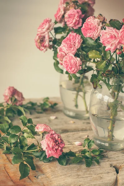 Розовые розы на деревянном столе — стоковое фото