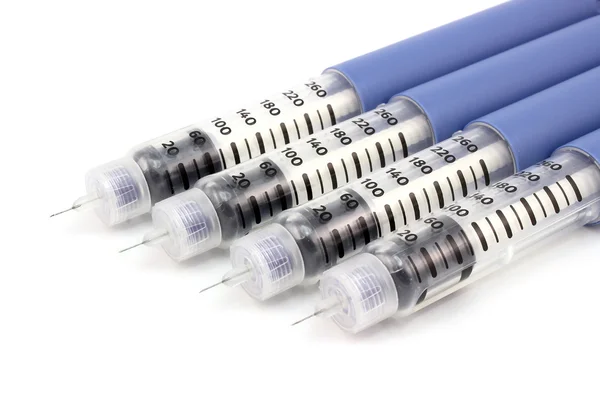 Four syringe pen with needles — Stock Photo, Image