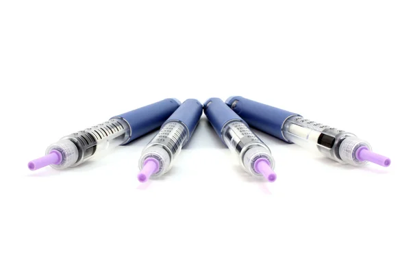 Four syringe pen with the needle — Stock Photo, Image