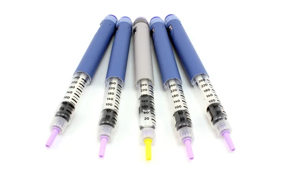 Four blue and one gray syringe pen — Stock Photo, Image