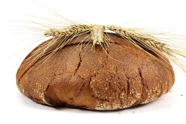 Ears of rye on a loaf — Stock Photo, Image