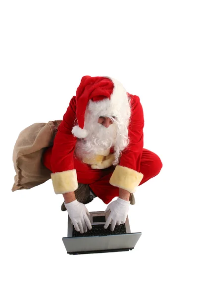 Santa Claus working on computer — Stock Photo, Image