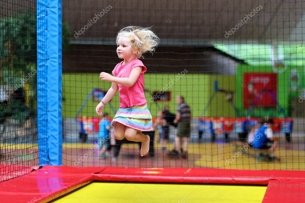 Little child jumping at trampoline — Stock Photo © CroMary 113838466