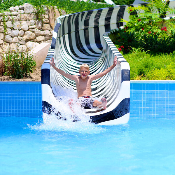 Boy having fun on water slide