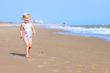 Yaz günü sahilde zevk mutlu yürümeye başlayan çocuk kız