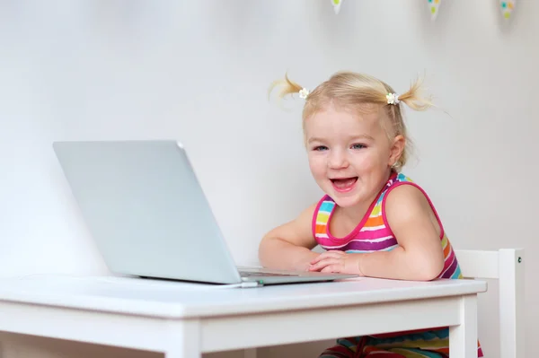 Cute little girl with laptop — Stock Photo, Image