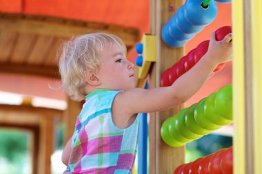 Preschooler girl at playground clipart
