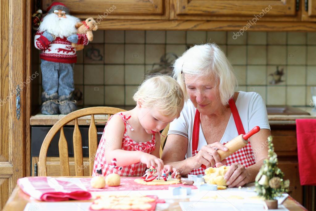 Grandmother making cookies with her granddaughter