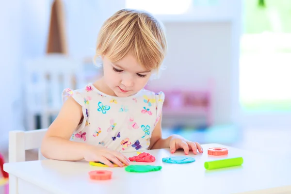 Niña pequeña creando con dinero de juego —  Fotos de Stock