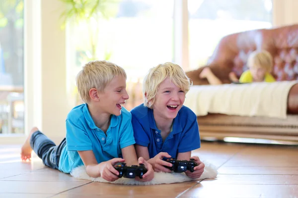 Dos hermanos jugando videojuegos en casa —  Fotos de Stock