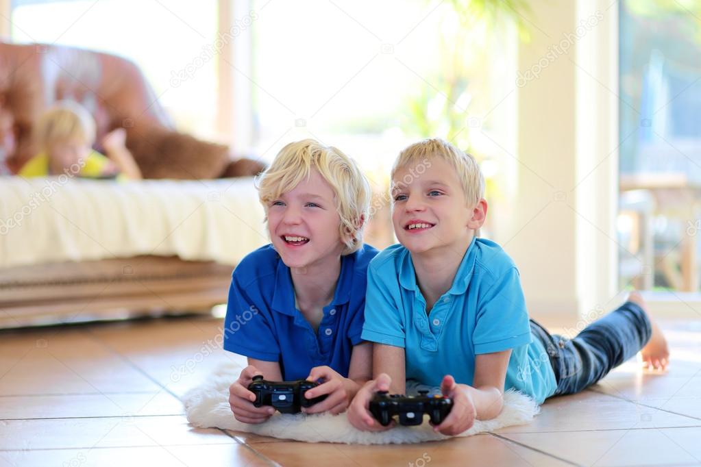 Two brothers playing video games at home