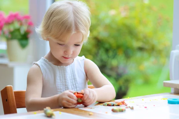 Toddler girl making plasticine cookies — Stock Photo, Image