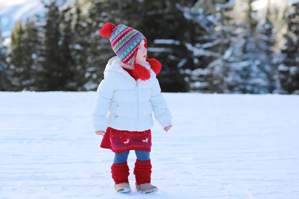 Little girl in Alpine resort at winter — Stock Photo, Image