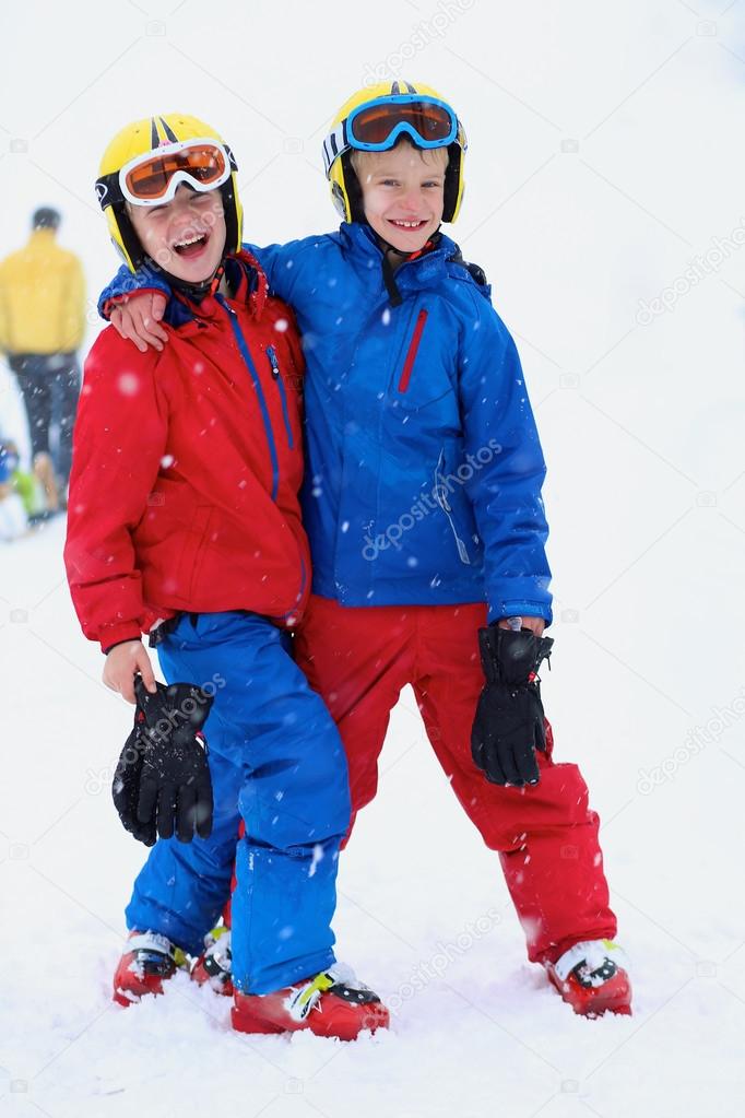 Two happy boys skiing in the Alps
