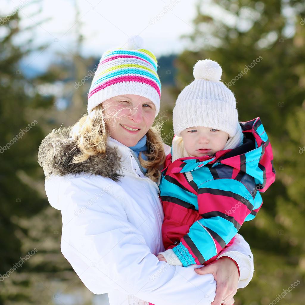 Mother and daughter in Alpine resort at winter