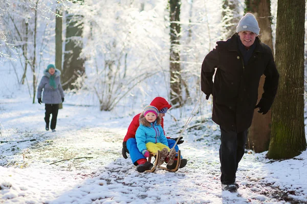 Avô feliz brincando com netos no inverno — Fotografia de Stock