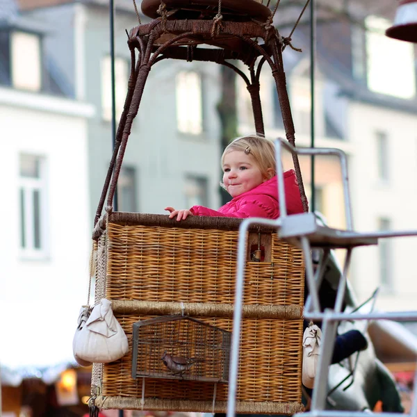 Happy girl enjoying merry-go-round — Stock Photo, Image