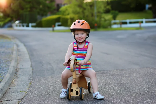 Liten flicka Rider trehjuling på gatan — Stockfoto