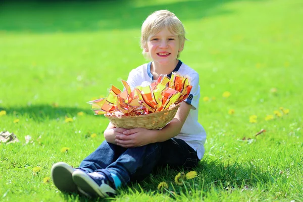 Happy school boy holding basket with easter eggs — Stock Photo, Image