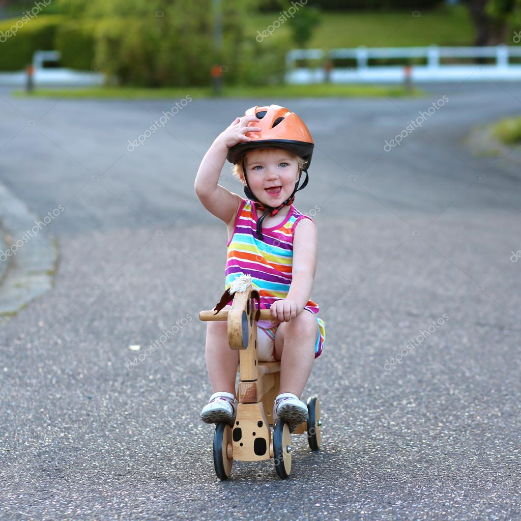 girl riding tricycle