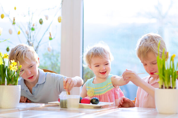 Group of kids decorating Easter eggs